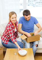 Image showing smiling couple unpacking kitchenware