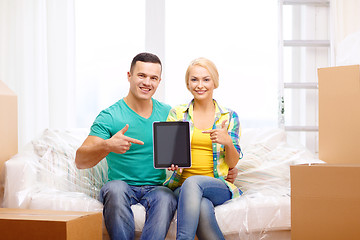 Image showing couple relaxing on sofa with tablet pc in new home