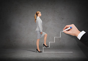 Image showing businesswoman stepping up staircase
