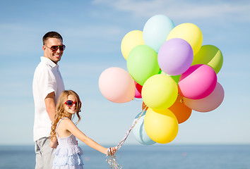 Image showing happy father and daughter with colorful balloons