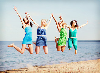 Image showing girls jumping on the beach