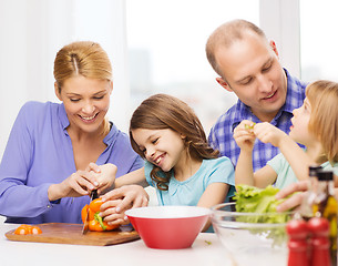 Image showing happy family with two kids making dinner at home