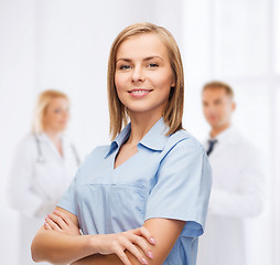 Image showing smiling female doctor or nurse