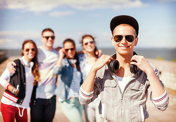 Image showing teenage boy with sunglasses and friends outside