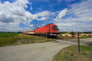 Image showing Train passing through a railway crossing.