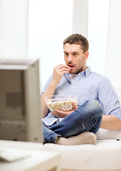 Image showing smiling man watching sports at home