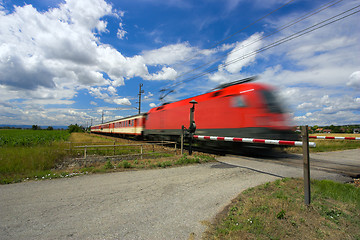 Image showing Train passing through a railway crossing.