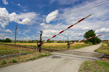 Image showing Train passing through a railway crossing.