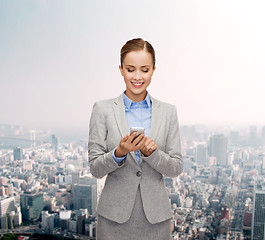 Image showing young smiling businesswoman with smartphone