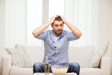Image showing sad man watching sports at home