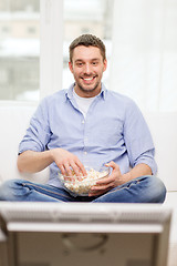 Image showing smiling man watching sports at home