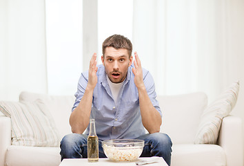 Image showing sad man watching sports at home