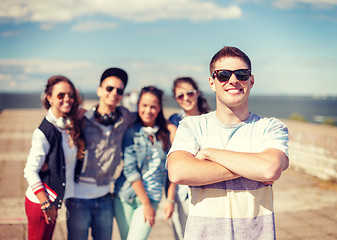 Image showing teenage boy with sunglasses and friends outside