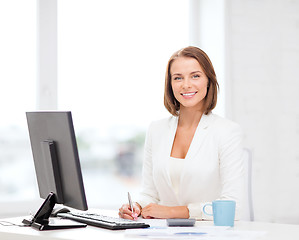 Image showing businesswoman with computer, documents and coffee