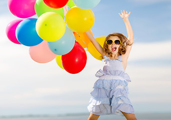 Image showing happy jumping girl with colorful balloons