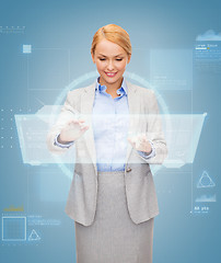 Image showing smiling businesswoman working with virtual screen