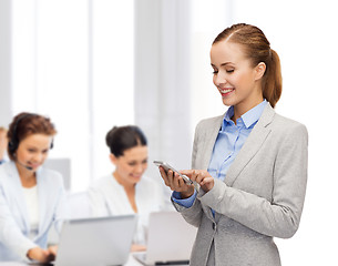 Image showing young smiling businesswoman with smartphone