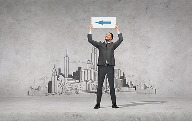 Image showing smiling businessman with arrow on white board