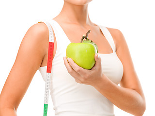 Image showing female hand with apple and measuring tape