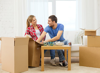 Image showing smiling couple unpacking kitchenware