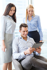 Image showing business team working with tablet pc in office