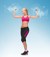 Image showing young sporty woman with light dumbbells