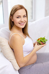 Image showing happy pregnant woman with bowl of salad