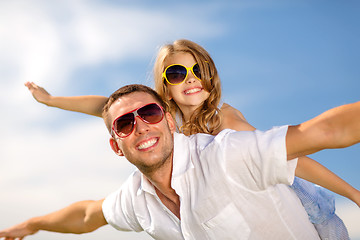 Image showing happy father and child in sunglasses over blue sky