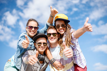 Image showing smiling teenagers in sunglasses hanging outside