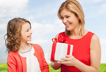 Image showing smiling mother and daughter with gift box