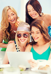 Image showing girls looking at tablet pc in cafe