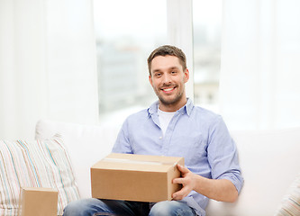 Image showing man with cardboard boxes at home