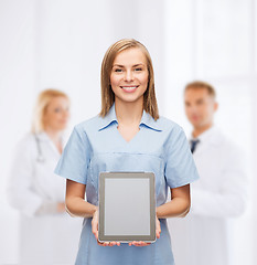 Image showing smiling female doctor or nurse with tablet pc