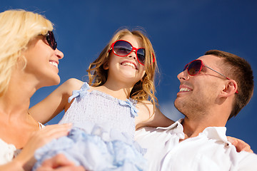 Image showing happy family in sunglasses over blue sky