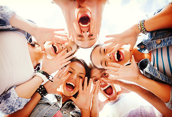 Image showing group of teenagers looking down and screaming