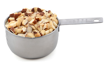 Image showing Chopped brazil nuts in a metal cup measure