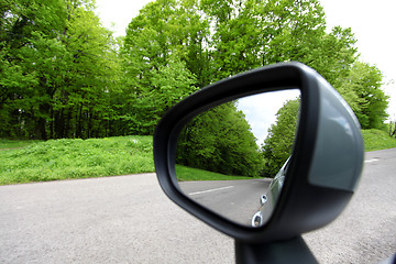 Image showing forest road reflection,  rearview car driving mirror view green 