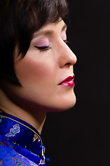 Image showing Beautiful young woman. Japanese makeup. Portrait on black