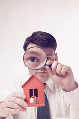 Image showing Man with magnifying glass house and paper