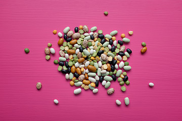 Image showing Mixed dried beans and peas on a pink background