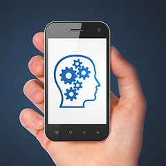 Image showing Advertising concept: Head With Gears on smartphone