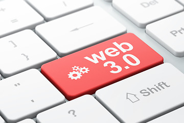 Image showing website development concept: Gears and Web 3.0 on computer keyboard