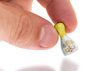 Image showing Hand holding wooden pawn, flag painting, selective focus