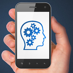 Image showing Marketing concept: Head With Gears on smartphone