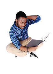 Image showing Black man sitting on floor.