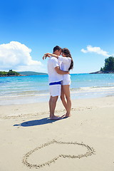 Image showing romantic  couple in love  have fun on the beach with heart drawi