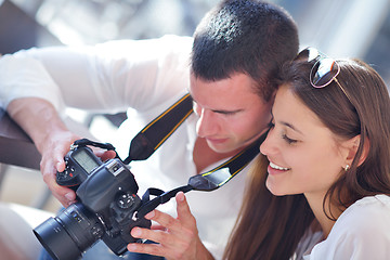 Image showing couple looking photos on camera