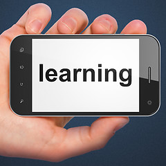 Image showing Hand holding smartphone with word learning