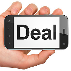 Image showing Hand holding smartphone with word Deal on display. Generic mobil