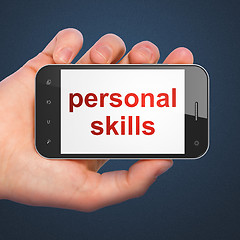 Image showing Hand holding smartphone with word personal skills